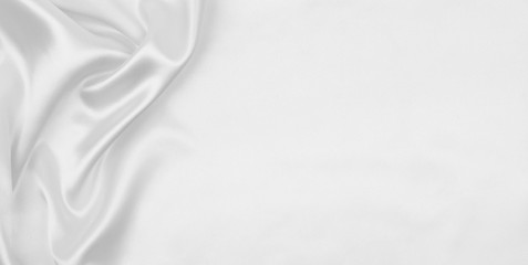Obraz premium Smooth elegant white silk or satin luxury cloth texture as wedding background. Luxurious background design