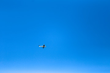 small plane in blue sky 