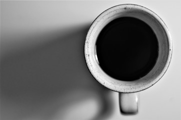 a coffee mug from the top, in black and white