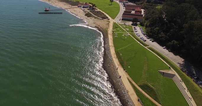 Fort Point National Historical Site in San Francisco, California. Aerial view of the grass field and Downtown SFO. Reveal city on  TILT UP drone shot.