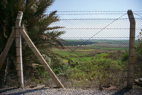 View of chain link and barbed fence with concrete poles