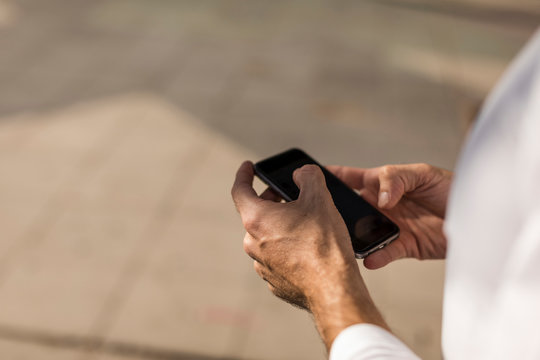Man using mobile phone to discover new yoga poses