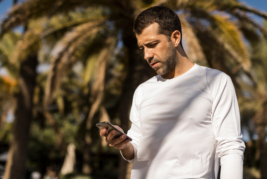 Man using mobile phone to discover new yoga poses