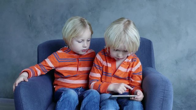 Cute Kids Playing Games On Smartphone.
