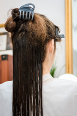 Fototapeta premium Zabieg keratynowy u fryzjera - Keratin treatment at the hairdresser