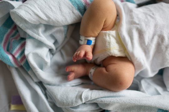 Overhead of Newborn Boy's Legs, Feet, Toes in Hospital Bassinet