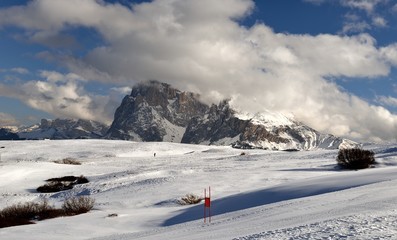 Winter panorama of italian ski resort with background of Seiser Alm, Alpe di Siusi, a high altitude alpine meadow in Dolomites with Langkofel and Plattkofel mountains under snow, South Tyrol, Italy.