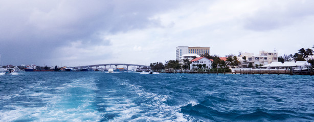 Distant buildings and bridge during a boat-ride in the Ocean near Nassau in The Bahamas.