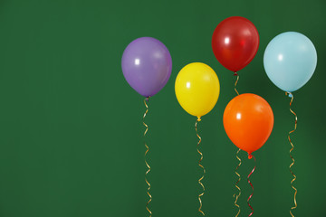 Bright balloons on color background, space for text. Celebration time