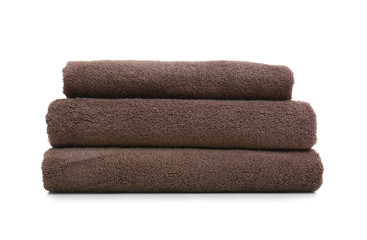 Stack of clean folded towels on white background