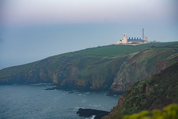 white lighthouse on the coast of england