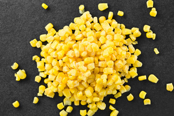 Frozen sweet corn kernels photographed overhead on slate (Selective Focus, Focus on the corn...