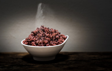 Riceberry rice in white bowl with  on the wooden table Ready to eat
