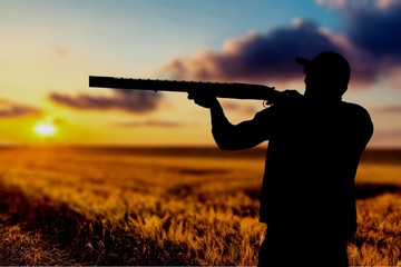 Fototapeta premium Male Hunter with Rifle on natural background