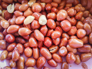 Deep fried peanuts on plate background