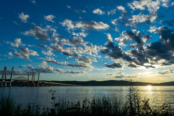 Tappan Zee Bridge leading across the Hudson River toward New Jersey, while a beautiful sunset lights up the cloud-filled sky in the West, Tarrytown, Upstate New York, NY