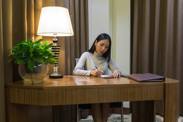 Beautiful asian girl is working on her desk in the private office
