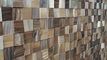 Lovely wooden wall assembled of square boards of wood