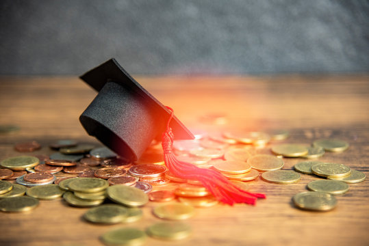 Scholarship For Education Concept With Graduation Cap On Money Coin Wooden Table