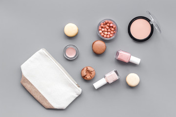 make-up accessories and fashion stylish cosmetics on gray desk background top view pattern
