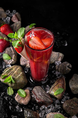 Lemonade from strawberry puree and berries. Summer soft drink based on citruses, berries, sugar syrup, mint and ice. Cocktail card for a bar or restaurant.