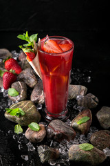 Lemonade from strawberry puree and berries. Summer soft drink based on citruses, berries, sugar syrup, mint and ice. Cocktail card for a bar or restaurant.