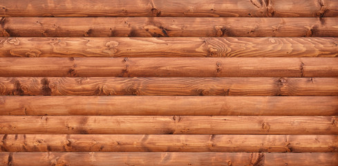 Wooden wall assembled of beams or logs - obrazy, fototapety, plakaty