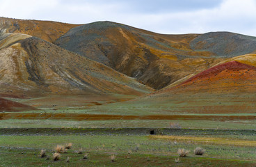 A fantastic view of colorful and brilliant  mountains with green grass.