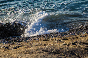 Sea wave splash on rocky beach