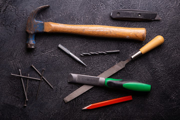 Handyman tools on black textured background