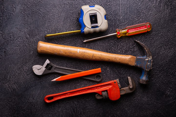 Handyman tools on black textured background