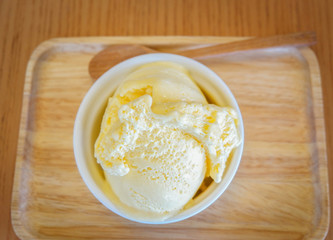 ice cream cup on wooden tray / Yellow vanilla ice cream scoop