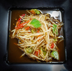 Hot and spicy thai food green papaya salad on plate