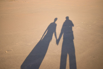 shadow from a couple on the beach