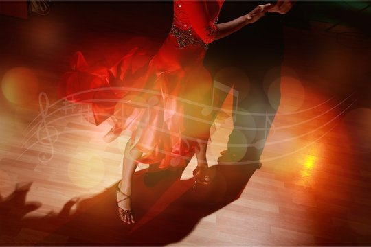Man and a woman dancing Salsa on background