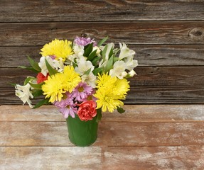 Spring flower bouquet on wood table