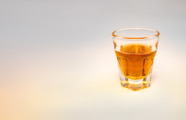 Whiskey glass with decorative lights on a white gradient background Celebration drinking concept Text entry area