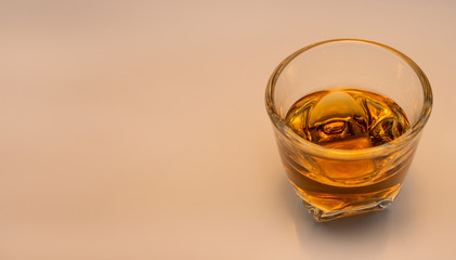 Whiskey glass with decorative lights on a white gradient background Celebration drinking concept Text entry area