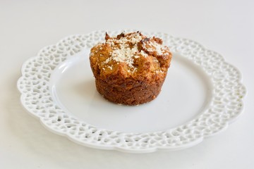Tasty carrot muffin on the white plate