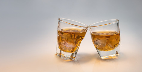 Whiskey glass with decorative lights on a white gradient background Celebration drinking concept Text entry area