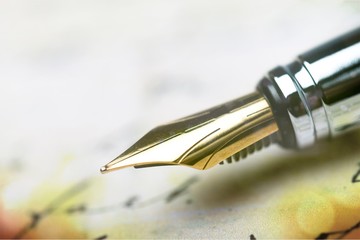 Close-up of Vintage Fountain pen on paper for business background