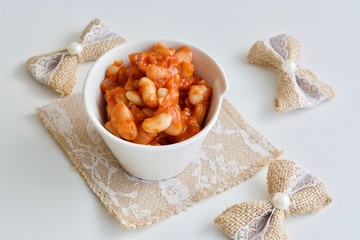 Tasty white kidney beans in the red tomato sauce