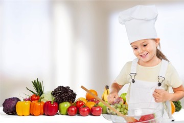 Portrait of adorable little girl preparing healthy food at kitchen