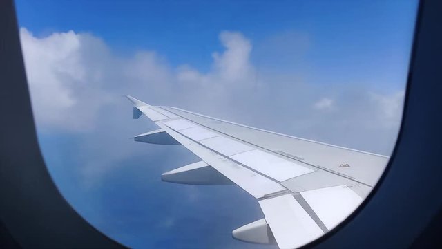Clouds passing over an airplane wing