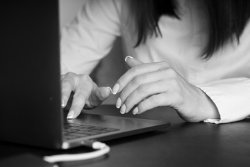 Woman working at office hand on keyboard close up