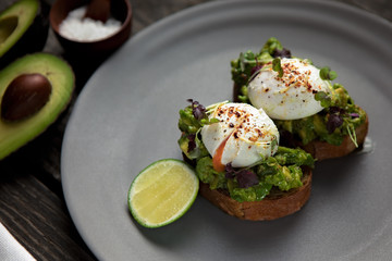 Poached eggs served on an avocados on toasts