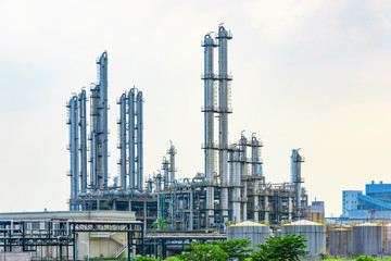 Oil refineries and storage tanks in the plant under the background of blue sky white clouds