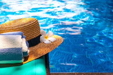 Exotic frangipani flower and hat Lounge Chair by Swimming Pool