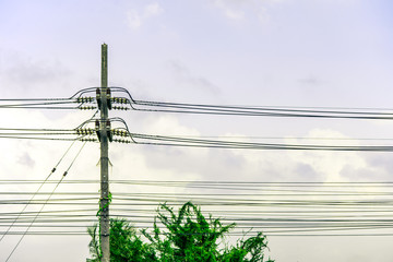 Row of electricity pole on green nature road in Thailand, Transmission line of electricity to...