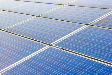 Solar power and photovoltaic panels under the blue sky white clouds.
